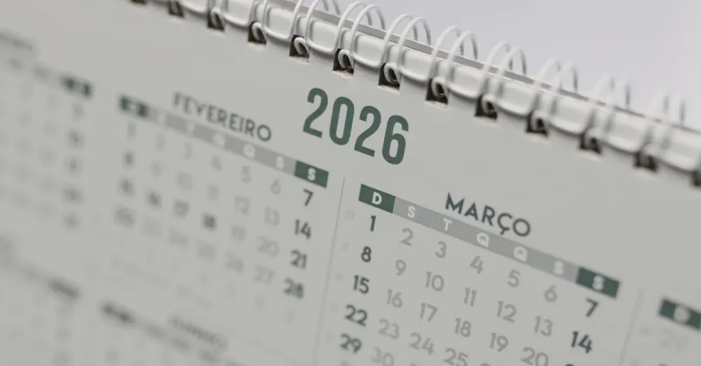 Spiral-bound desk calendar showing the months ahead